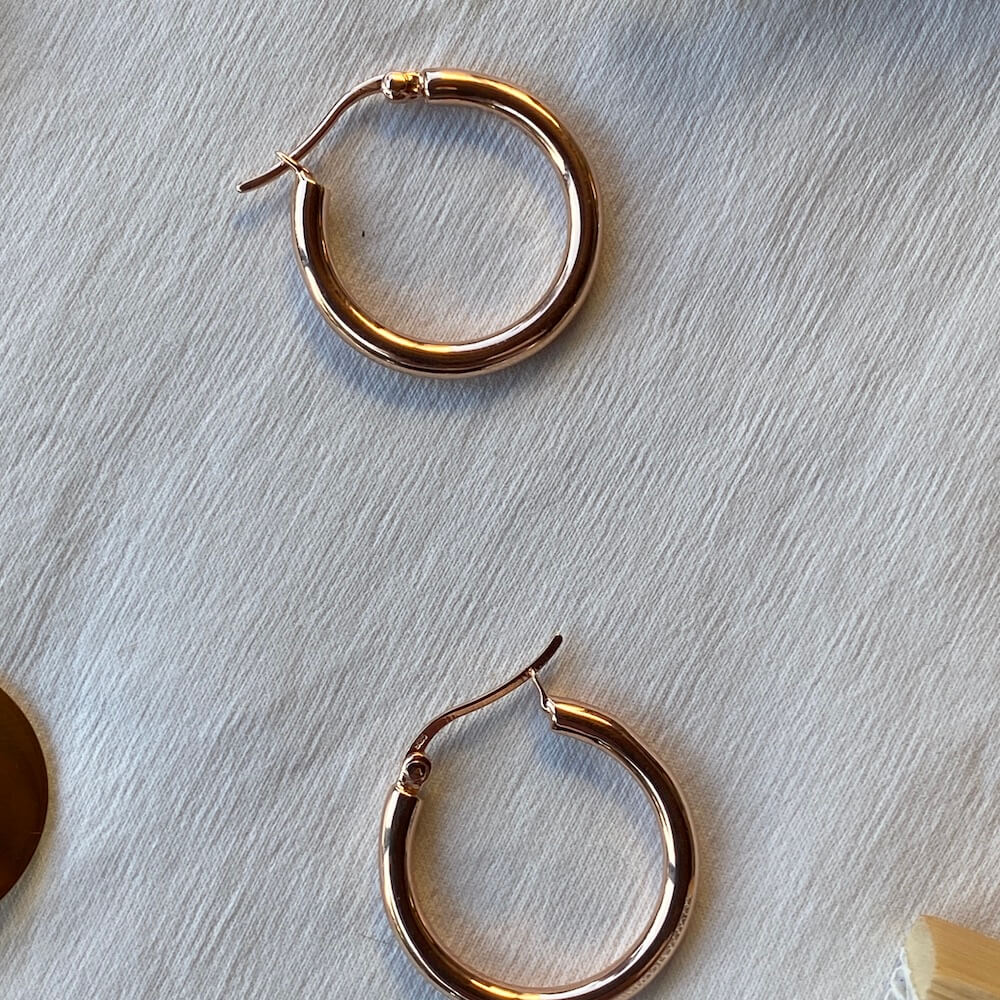 Close up of large rose gold hoops