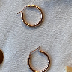 Close up of large rose gold hoops