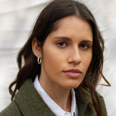 A model with a large silver hoop in her ear