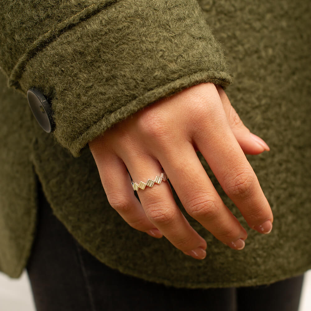 Angular textured solid sterling silver ring being worn by a model