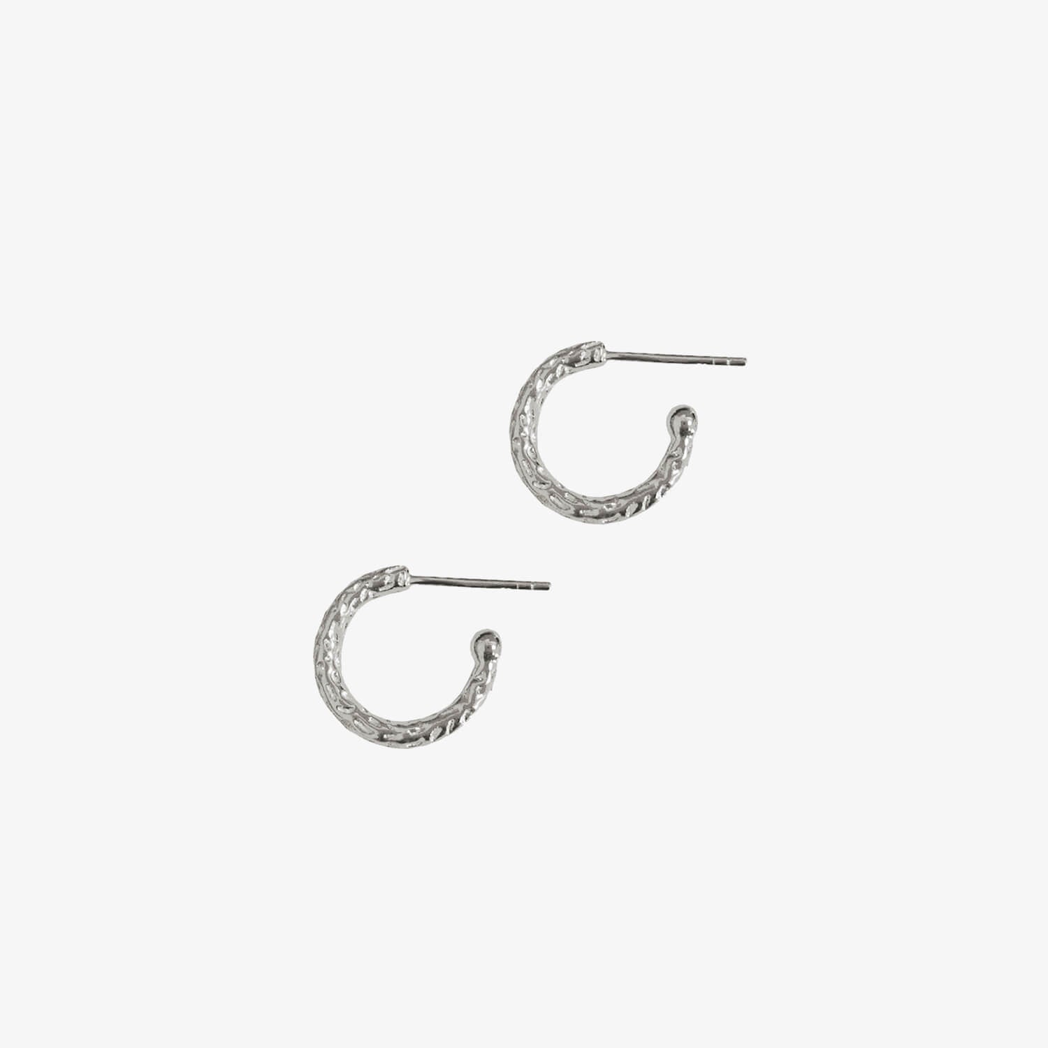 Small silver textured huggy hoops on a white background