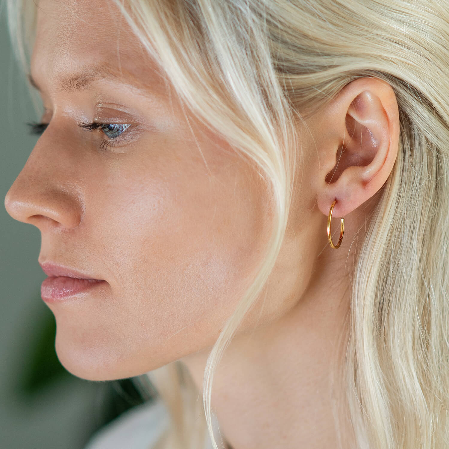 A woman wearing Thin Wire Hoops