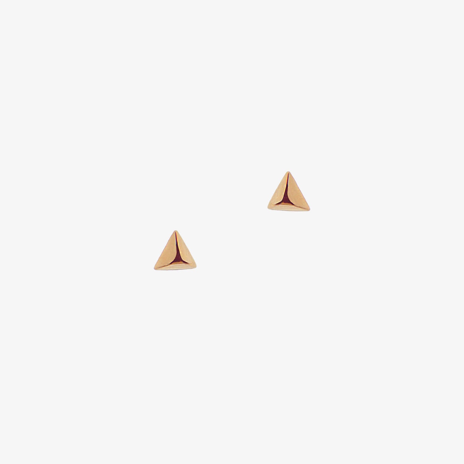 Dainty triangle rose gold earrings on a white background
