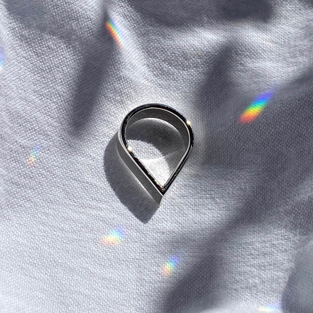 A Wide Point Ring in silver on a rough cloth background